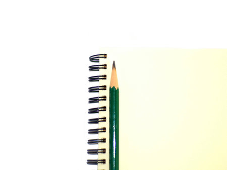 green pencil on a plain ring binder notebook, right alignmentの写真素材