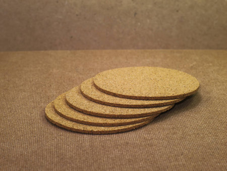 a pile of hot cup serving tray made of compressed sawdust on wooden boardの写真素材