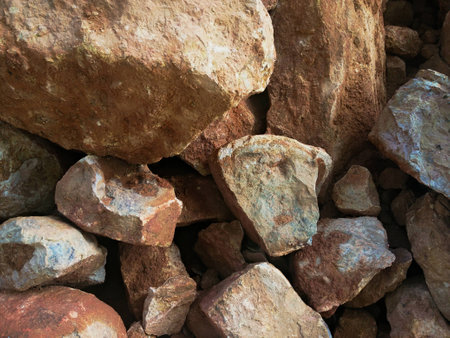 closeup shot of a pile of brown and grey rocks in various sizes
