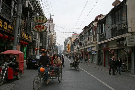 Shanghai, China - March 30, 2010 - A street view with bikes and pedi cabsのeditorial素材