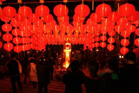 Shenzhen, China - February 3, 2011 -  A grid of Chinese red glowing lanterns greets tourists on their night arrival to Splendid China theme park in Shenzhenのeditorial素材