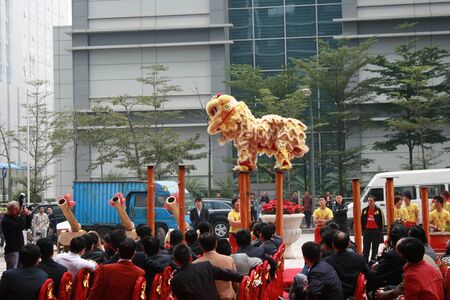Shenzhen, China - December 12, 2010 - A lion prepares to take the jump at a lion dance show for a company opening in Shenzhenのeditorial素材
