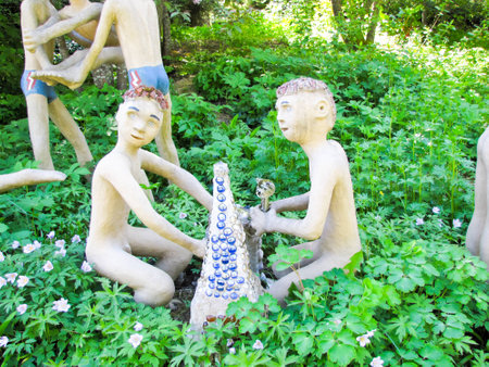 funny figures made of wood and stone on a background of treesの写真素材