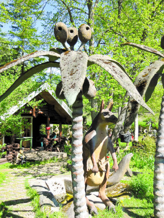 funny figures made of wood and stone on a background of treesの写真素材
