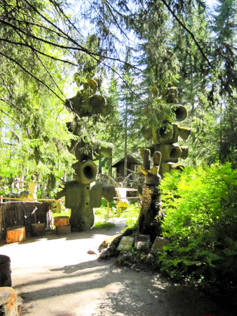 funny figures made of wood and stone on a background of treesの写真素材