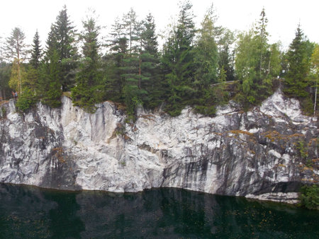 the river flows among rocks and treesの写真素材