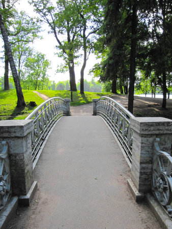 stone bridge across the river on a background of green treesの写真素材