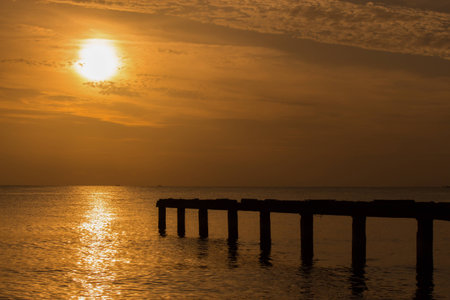 wonderful sunrise with gold light and black piper at Songkhla, Thailandの写真素材