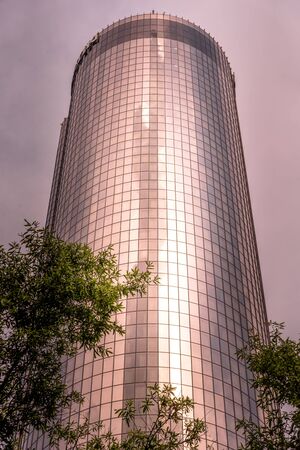 Atlanta, Georgia/USA - July 7th 2019: Reflection of clouds and city in modern building during sunset