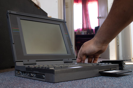 hands of a person using an old laptop