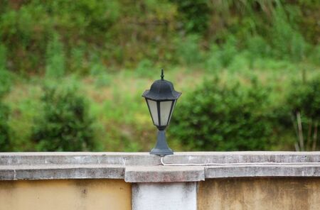 street lamp on the wall with green backgoundの写真素材