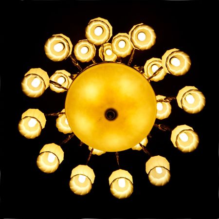 Looking up to crystal chandelier in a hall  の写真素材