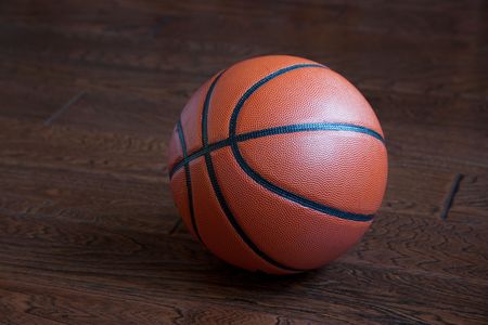 Basketball on the hardwood basketball floor in a stadiumの写真素材