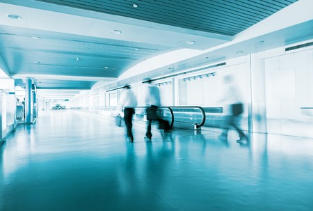 People Walking in Airport Tunnel with moving walkway, long exposureの写真素材