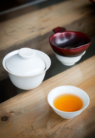 Simple Chinese tea set - small teacup,teabowl and  tea  filter on wooden table の写真素材