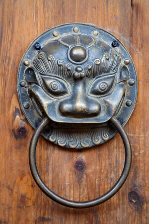 Chinese unicorn door knob on wood.Chinese unicorn, also name kylin,is an auspicious symbol in chinaの写真素材