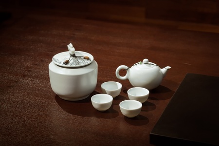 Tea  Set on a Wooden Table in a traditional asian tearoom, include  teapot and teacups and tea caddy の写真素材