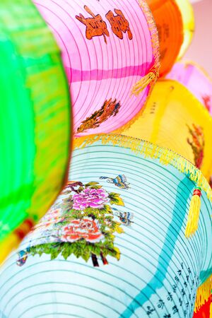 Colorful Chinese paper lanterns hanging in a street market prepared for Chinese spring festival The letters on lantern means riches and honor,blessing word in Chinese new year の写真素材