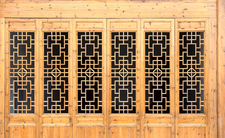 Closeup Chinese old wooden frame door with decorative pattern under the sunshine ,view from inside of building.の写真素材