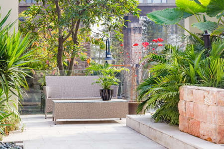 Backyard with cane chair and table in a Garden