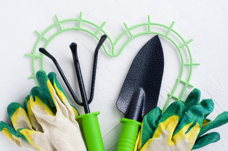 Gardening tools on white background, flat lay, copy space, top view. Concept of hobby, springtime, garden maintenance, landscaping, transplanting plants, gardening at home.の写真素材