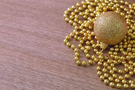 christmas golden decoration over wood background with copy space.の写真素材