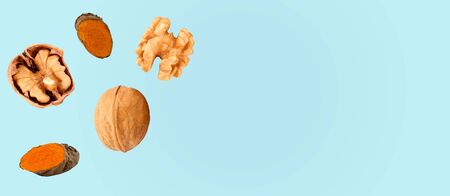Composition with walnuts and turmeric on color background, top viewの写真素材