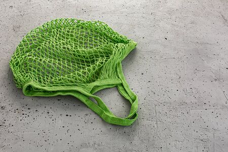 Green eco cotton string bag on a concrete backgroundの写真素材