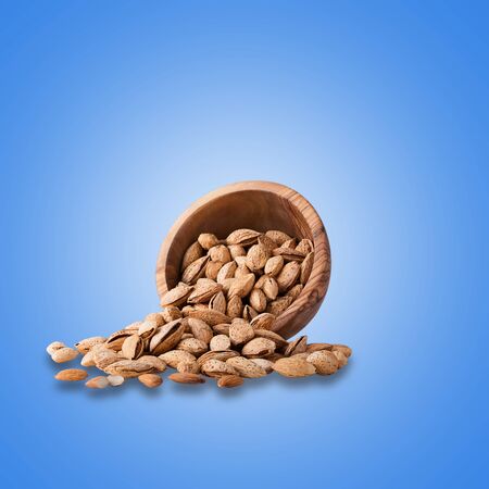 Fresh almonds isolated on light blue backgroundの写真素材