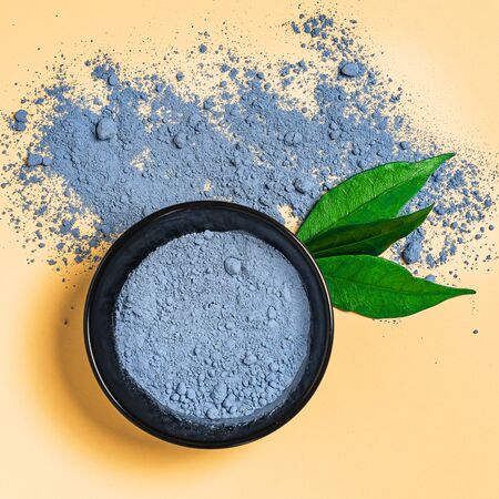 Close-up blue powder matcha tea isolated on trendy colour surfaceの写真素材