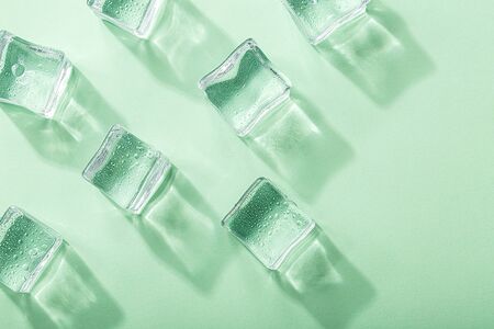 Colored banner with fresh ice cubes and reflectionsの写真素材