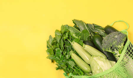Food vegetable in eco grocery bag on yellow backgroundの写真素材
