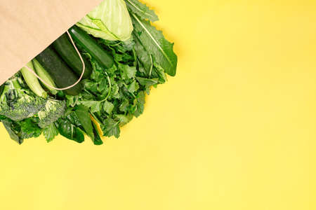 Food vegetable in eco grocery bag on yellow background