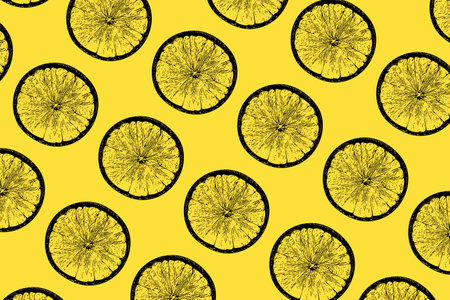 Lemon slices pattern on vibrant illuminating color background. Minimal flat lay food texture