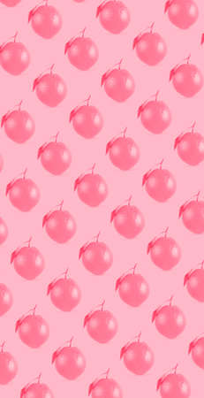 Whole orange fruit pattern on pastel pink color background. Minimal flat lay food texture