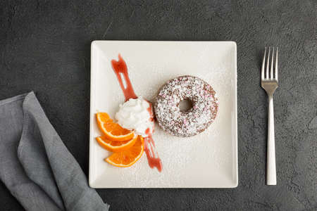 doughnut on plate isolated on black background