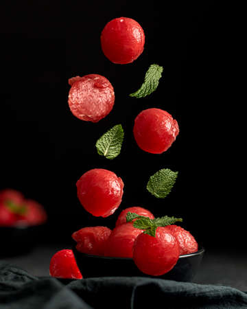Creative concept with falling food on black backdrop