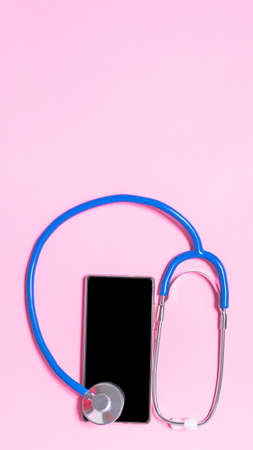 Stethoscope on pastel pink background from aboveの写真素材