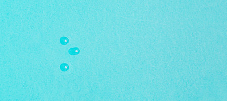 drops of vaccine on pastel blue background from above