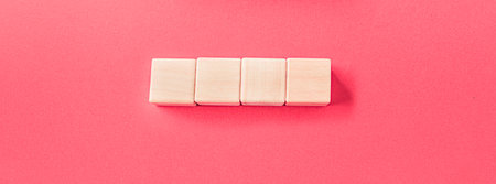 Wooden toy blocks on soft pink backgroundの写真素材