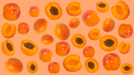 Falling apricot ruits on orange surface for advertisementの写真素材