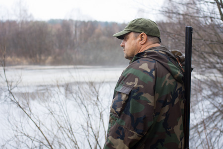 the hunter looks at the lakeの写真素材