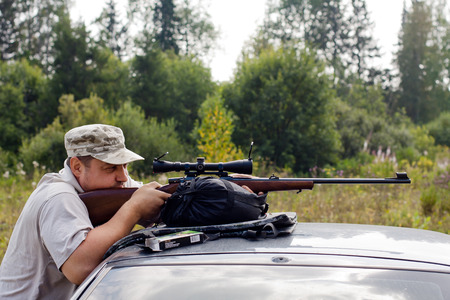 the man aiming from a rifle