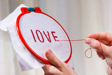 hands embroider cross-stitch a word loveの写真素材
