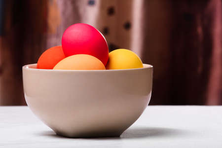 easter eggs in white bowl on the tableの写真素材