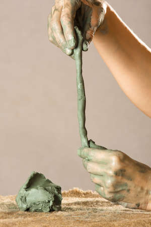 hands of women working with blue clay, closeupの写真素材