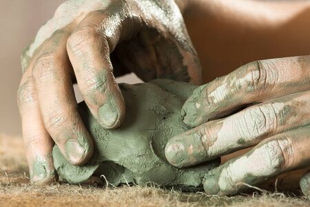 hands of women working with blue clay, closeupの写真素材