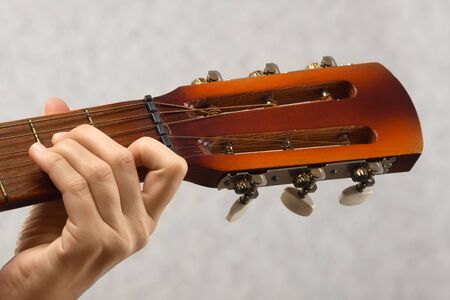 closeup of guitarist hand playing acoustic guitar