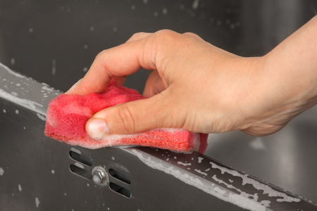 closeup of woman hand cleaning sink in the kitchenの写真素材