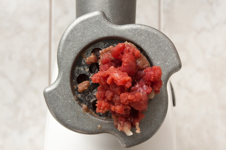 meat grinder with forcemeat in the kitchenの写真素材